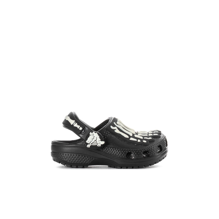 Toddler black clog with glow skeleton graphic, white accents, slip-on style.