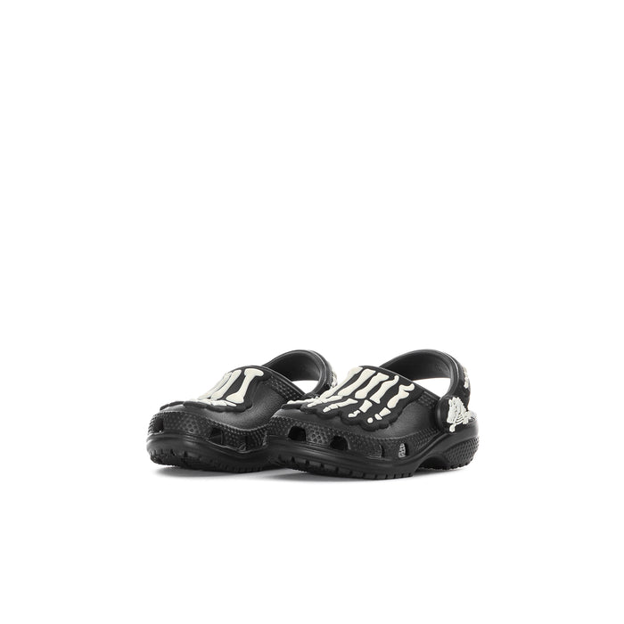 Toddler black clog with white skeleton graphic on uppers, textured tread sole.