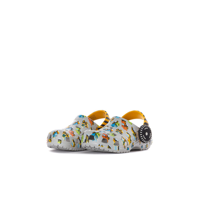 Toddler clog in white with colorful car pattern, orange strap, and dark side detail