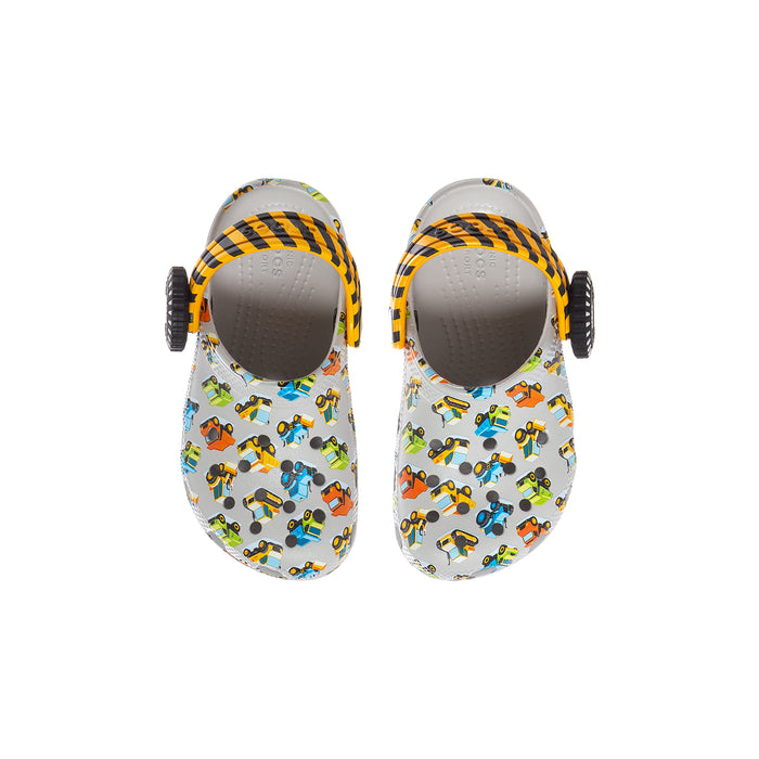 Pair of toddler clogs with white car print and orange/yellow striped heel strap