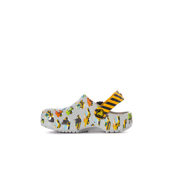 Toddler clog with white base and colorful vehicle print, orange/yellow striped strap