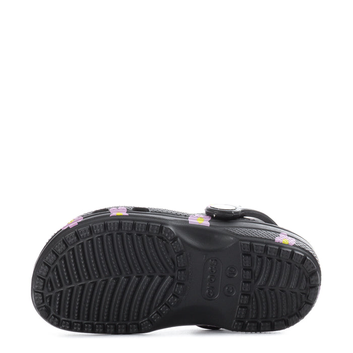 Toddler clog outsole tread on black bottom, pink flower uppers visible at sides