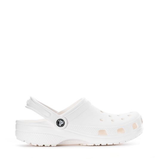 Youth white clog with vented upper and round logo patch, side profile.