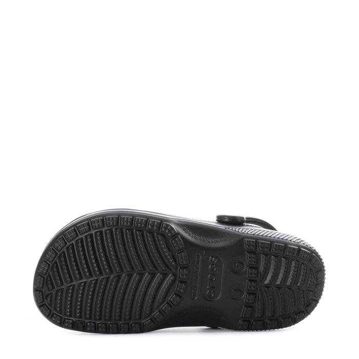 Youth black clog outsole view with deep tread and molded traction patterns.
