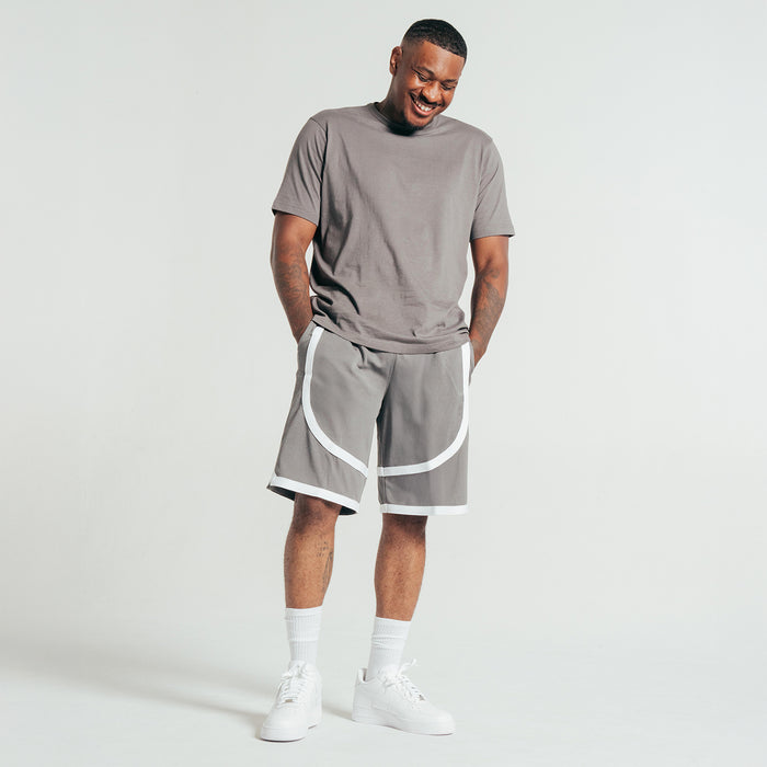 Castlerock gray crew T-shirt with short sleeves, knotted hem, worn with shorts.