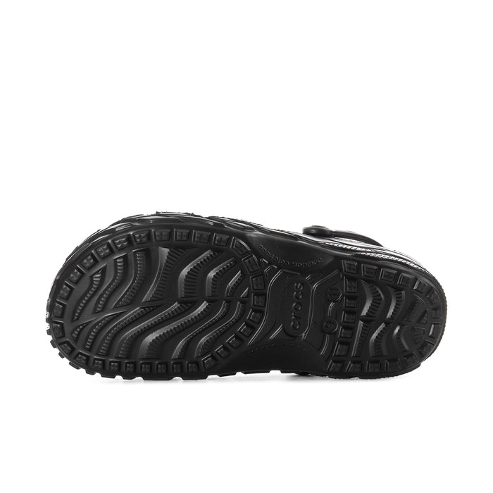 Black men's clog outsole view with deep tread pattern and textured traction grooves.