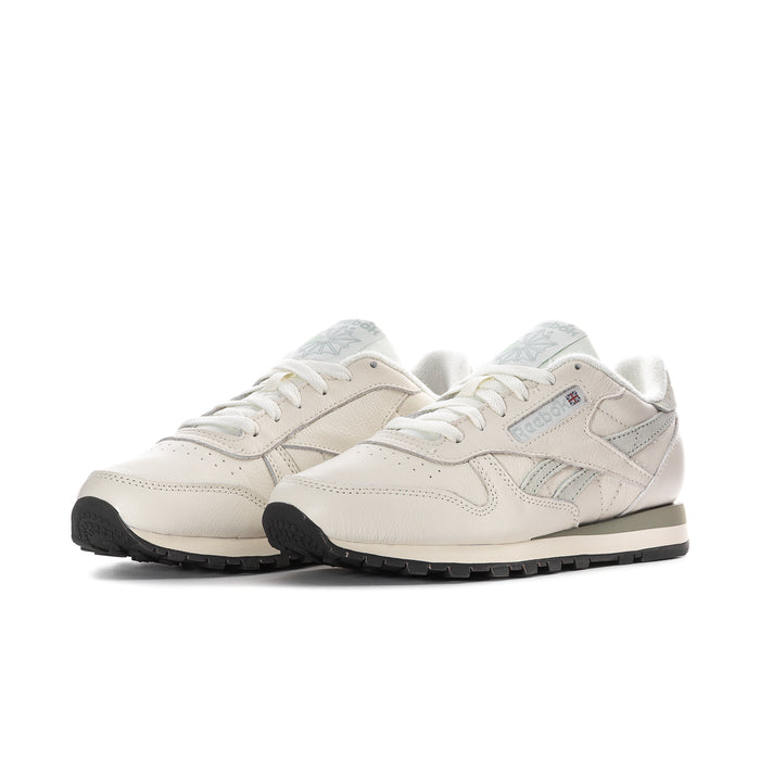 Pair of women’s off-white leather lace-up sneakers with light blue side panels and dark sole