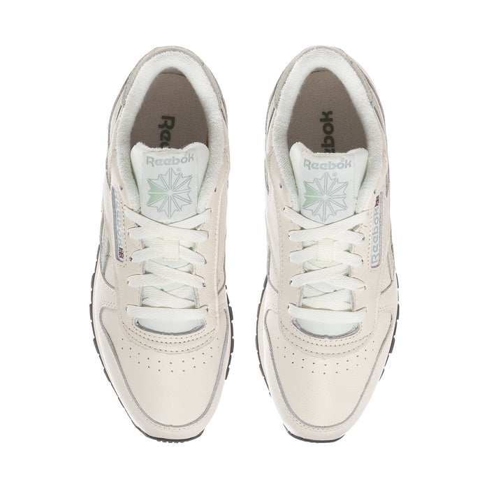 Women’s off-white leather sneakers with lace-up design and Reebok logos on tongue