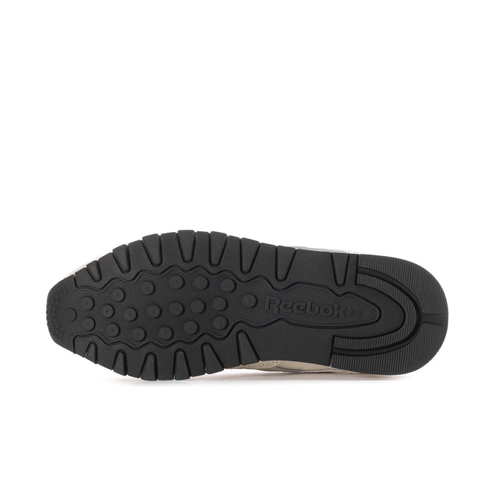 Women’s sneaker outsole view in black rubber with tread pattern and Reebok logo