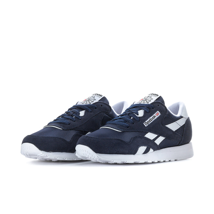 Men's navy low-top sneakers with white mid stripes, lace-up front view.
