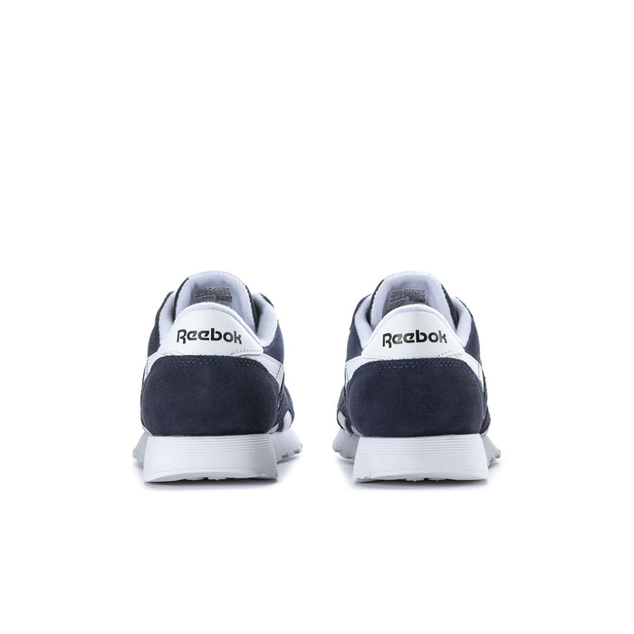 Men's navy low-top sneakers, rear heel view with white sole and Reebok branding.