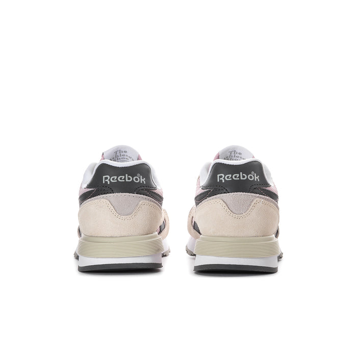 Women's Reebok sneakers, rear view with beige uppers, black heel tab, striped midsole