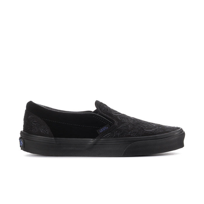 Women's black slip-on sneaker with embossed rose texture and rubber sidewall