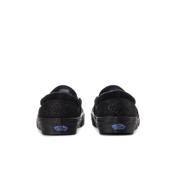 Women's black slip-on sneakers, heel view with embossed rose texture