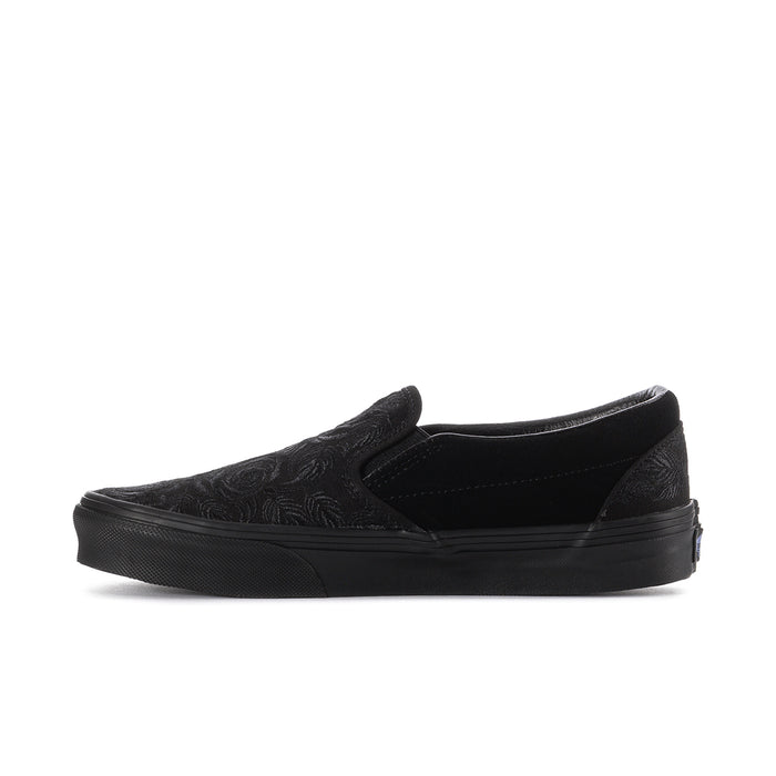 Women's black slip-on sneaker, side view, embossed rose upper and low profile sole