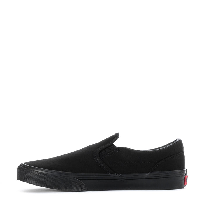 Vans youth black canvas slip-on sneakers, side view with red heel detail