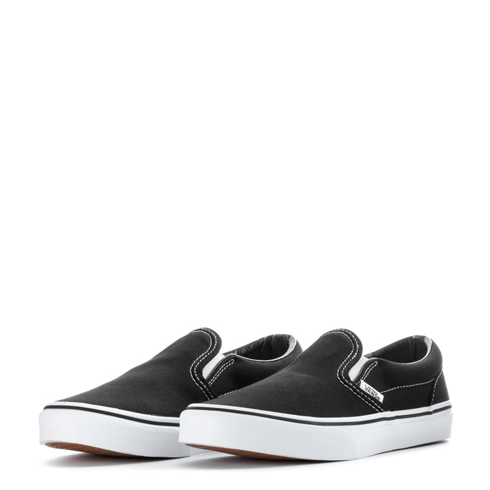 Pair of youth black slip-on sneakers with white soles and stitched side panels
