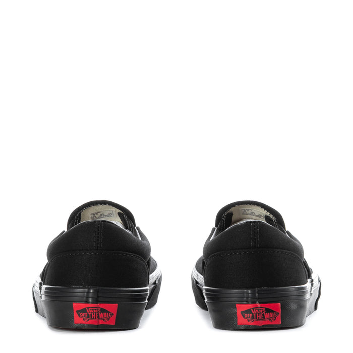 Vans youth black slip-on sneakers, back view with red logo patch on heel