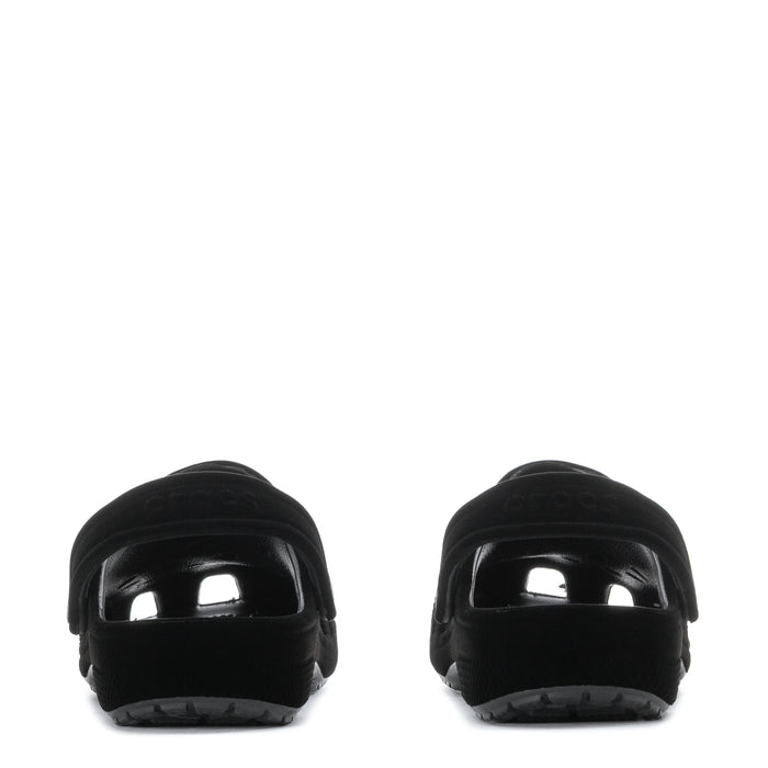 Youth black clogs heel view with glossy toe caps and textured sole