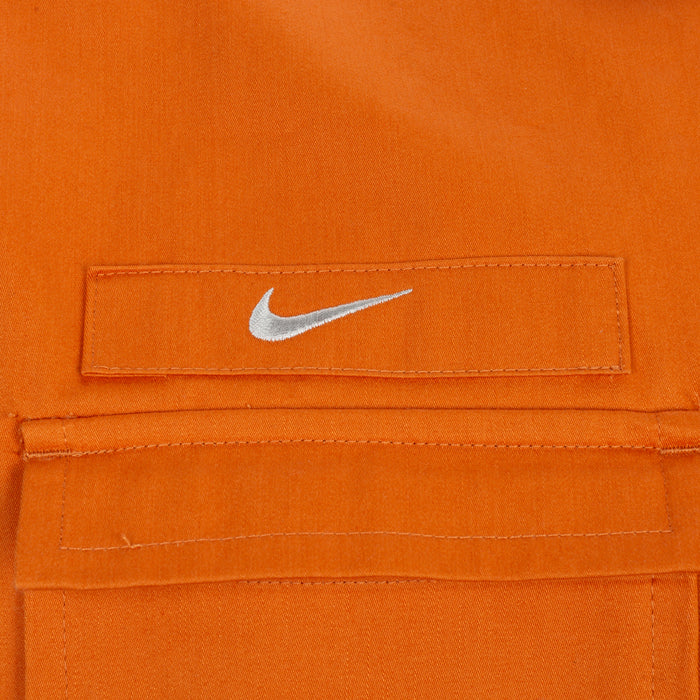 Orange woven shirt chest label with white swoosh logo