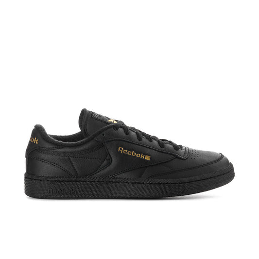 Black leather low-top sneaker with Reebok logo and gold accents