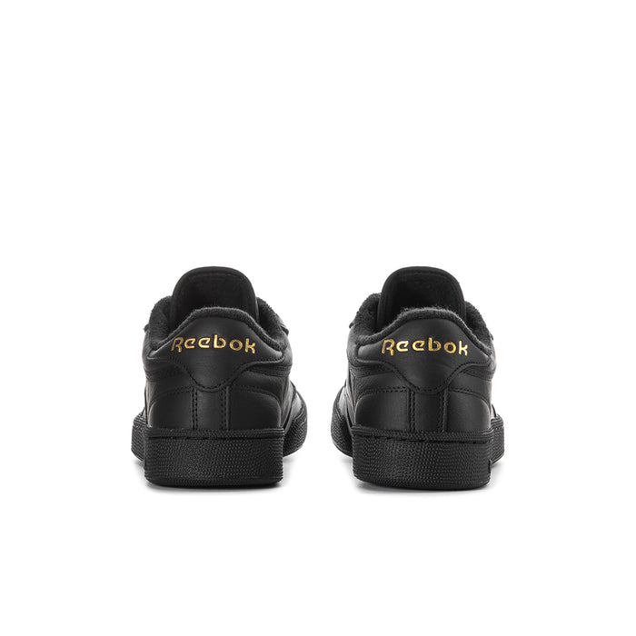 Black leather low-top sneakers with heel pull tab and Reebok logos