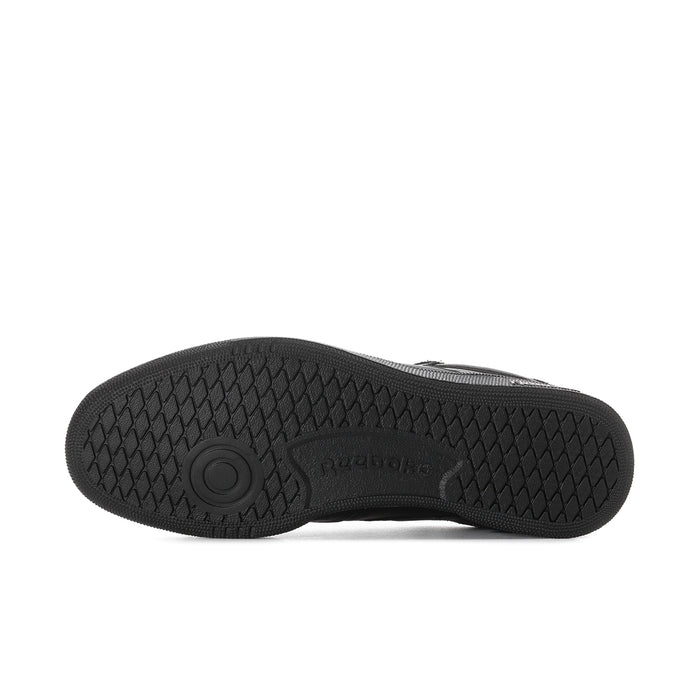 Black rubber outsole with textured traction pattern and circular Reebok mark