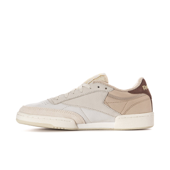 Beige and brown low-top sneaker with stitched overlays and lace-up front