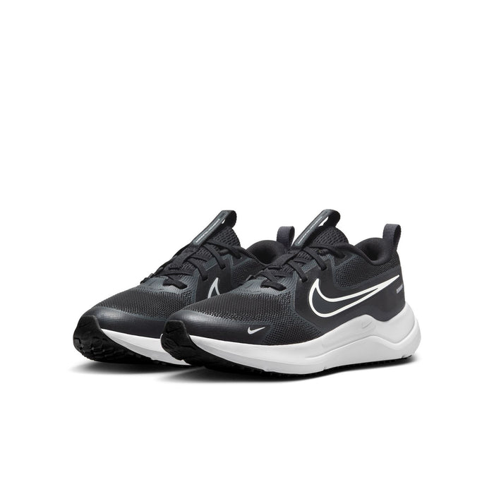 Pair of youth black running shoes with Nike swoosh, lace-up design, and white midsoles