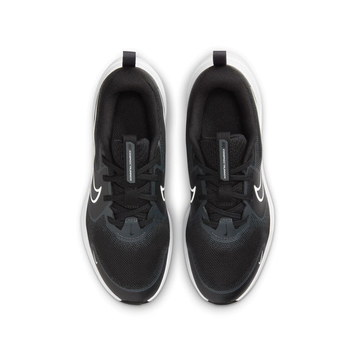 Youth black running shoes, top view with lace closure and contrasting swoosh logos