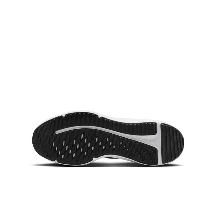 Youth black running shoe outsole with textured grip and white midfoot edge