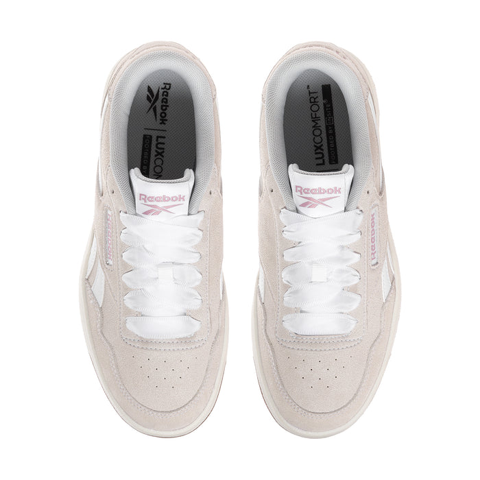 Women’s sneaker interior with white laces, light beige uppers, and comfort insole