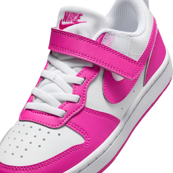 Kids sneaker upper close-up with white laces, pink strap, and pink NIKE swoosh
