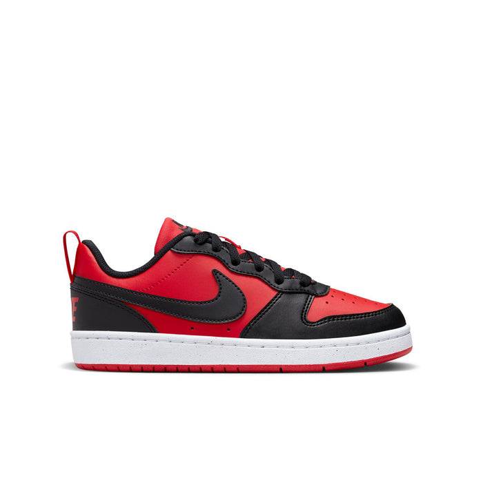 Youth low-top sneakers in red, black, and white with black swoosh and lace-up design.