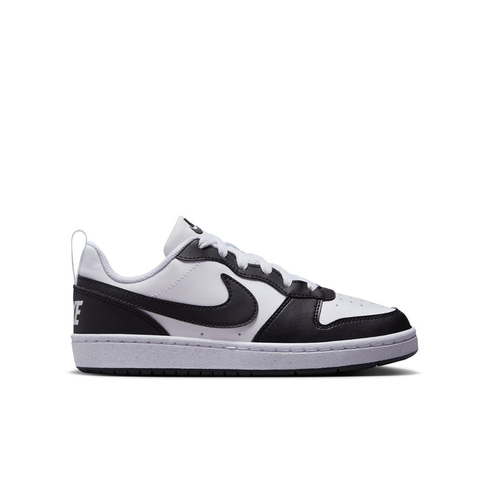 Youth low-top sneakers in white and black with swoosh logo and lace-up design