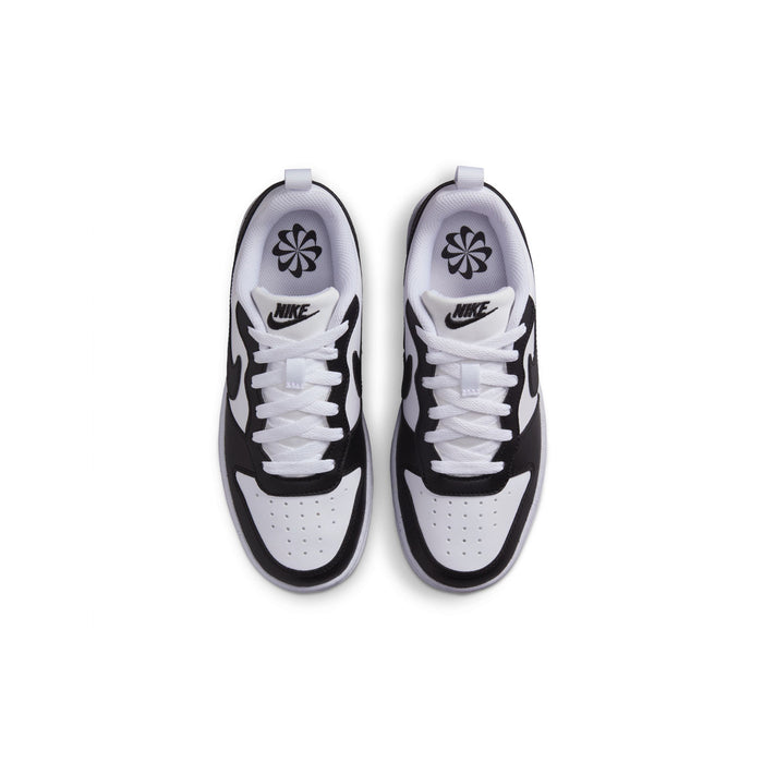 Pair of youth sneakers viewed from above, white uppers with black trim and swooshes