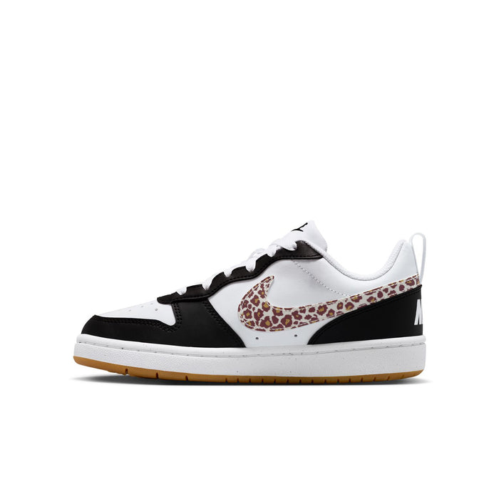 Youth low-top sneakers in white, black panels, and leopard print Nike Swoosh