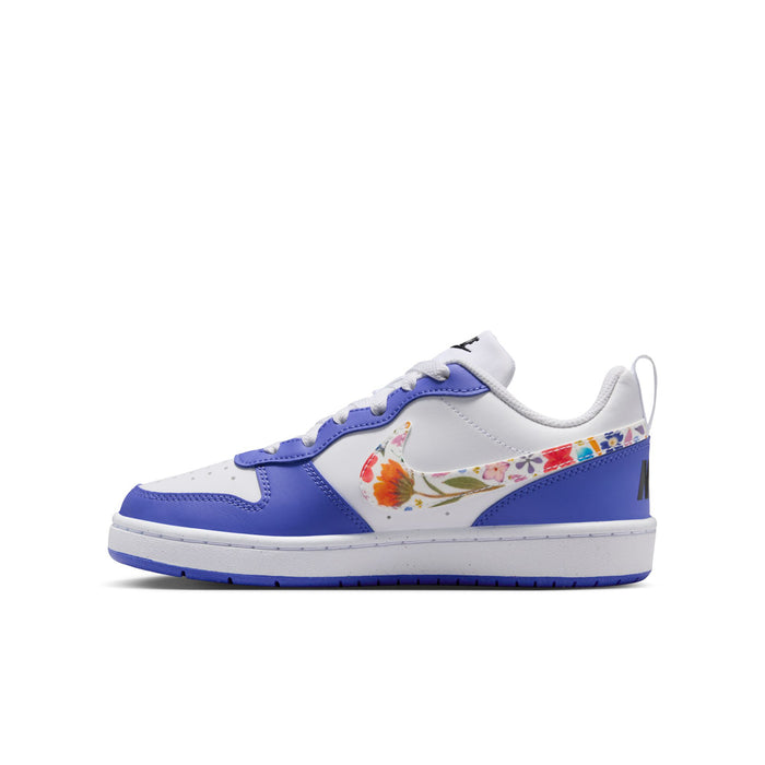 Youth low-top sneaker side profile in white and blue with colorful floral swoosh