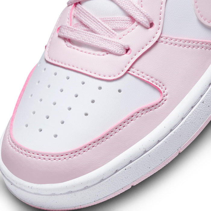 Youth sneaker upper close-up, white leather with pink trim and perforated toe