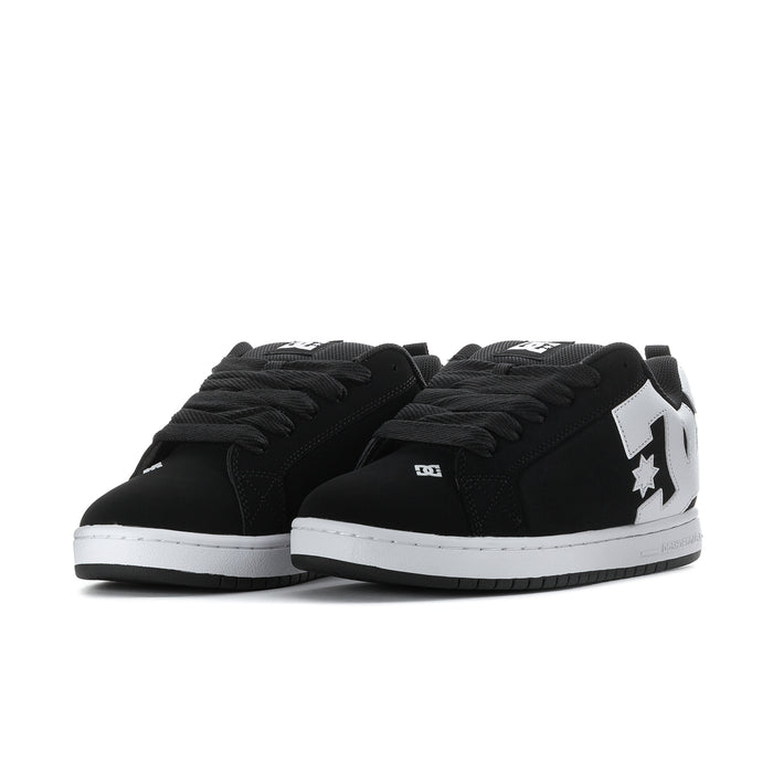 Black low-top sneakers with white star logo, showing the lace-up toe profile.