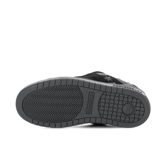 Youth black outsole view with tread pattern and DC logo on rubber sole