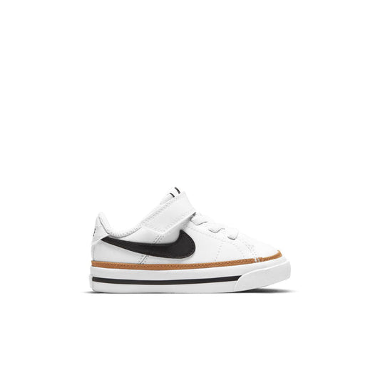 Toddler white sneakers with black NIKE swoosh and tan outsole trim