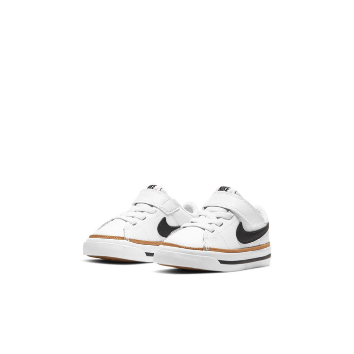 Toddler white sneakers with black swoosh and tan stripe detail
