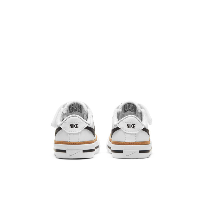 Toddler white sneakers with NIKE heel tab, black heel stripe, tan outsole
