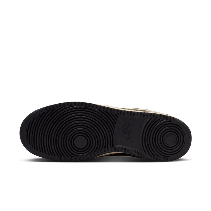 Rubber outsole of men's low-top sneakers in dark color, with circular tread pattern.