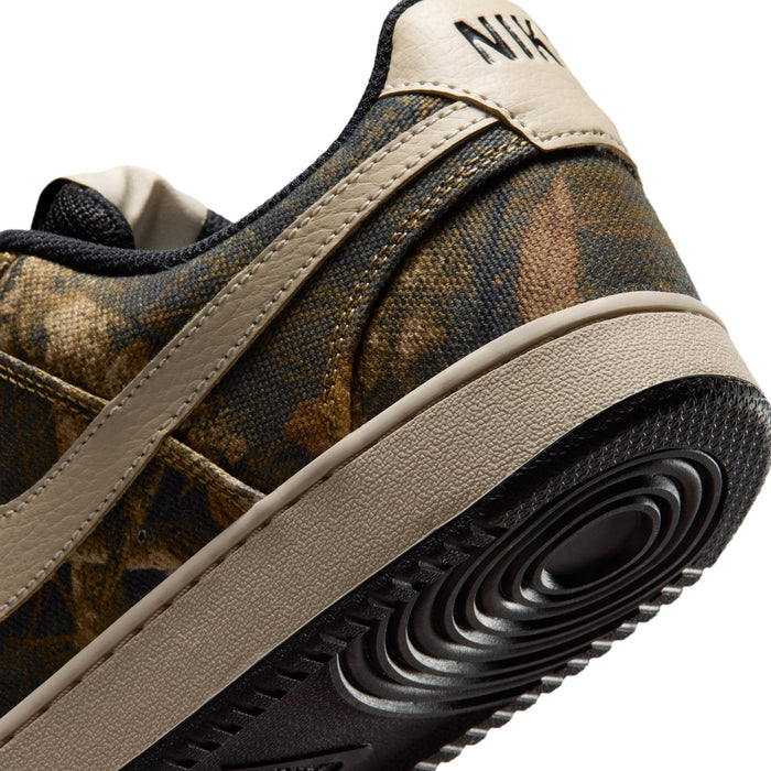 Close-up of men's low-top sneaker heel: brown camo upper, tan midsole, black tread.