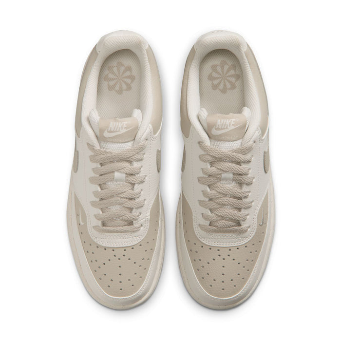 Pair of cream low-top sneakers showing padded tongue and insole branding