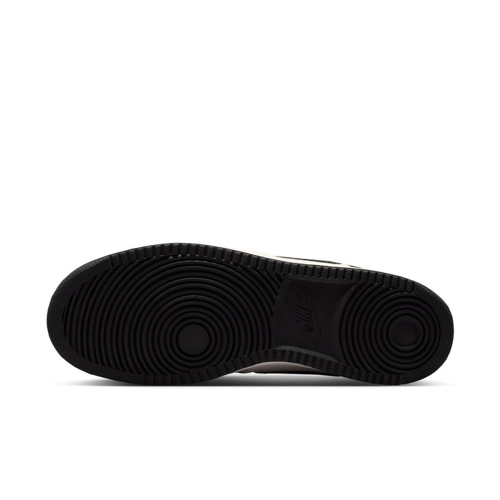 Men's sneaker outsole with black herringbone traction pattern.