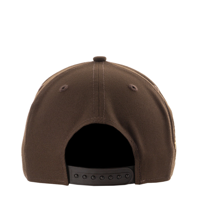Brown A-frame baseball cap back with adjustable strap and ventilation eyelets