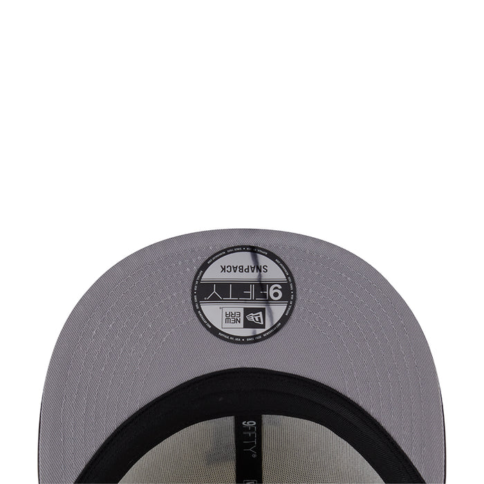 Two-tone baseball cap, dark gray underside with black circular New Era size label